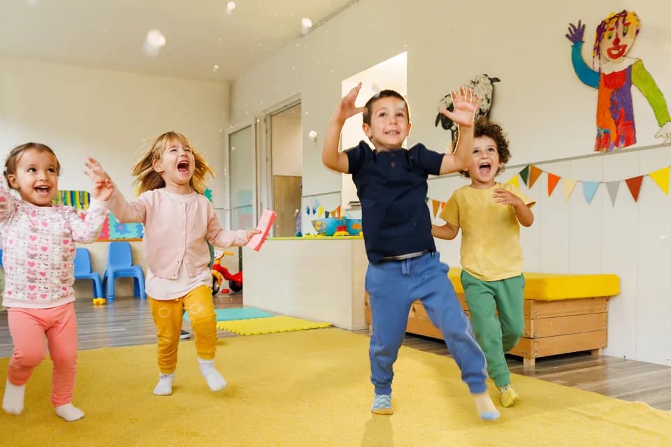 Preschoolers dancing together in a bright classroom